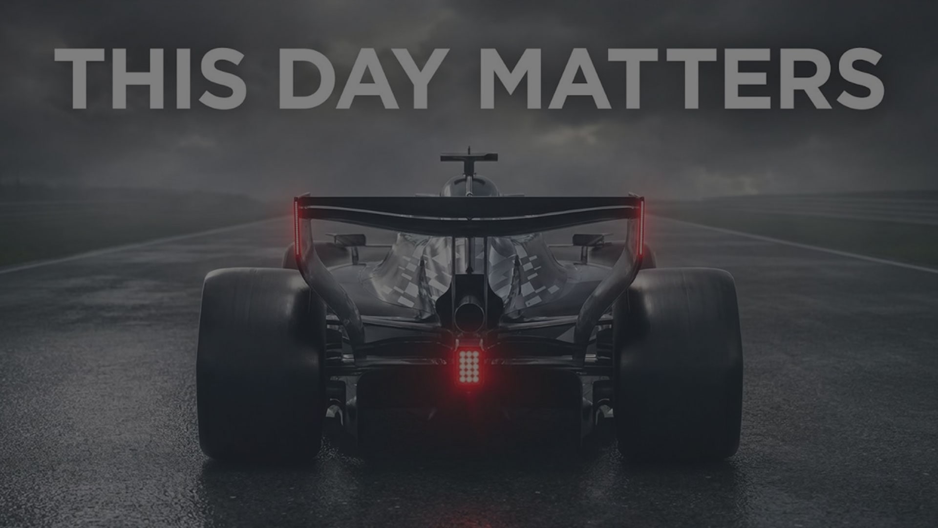 Rear View of the Cadillac F1 Racecar and its Brake Lights On with Text Overlay Reading "This Day Matters"