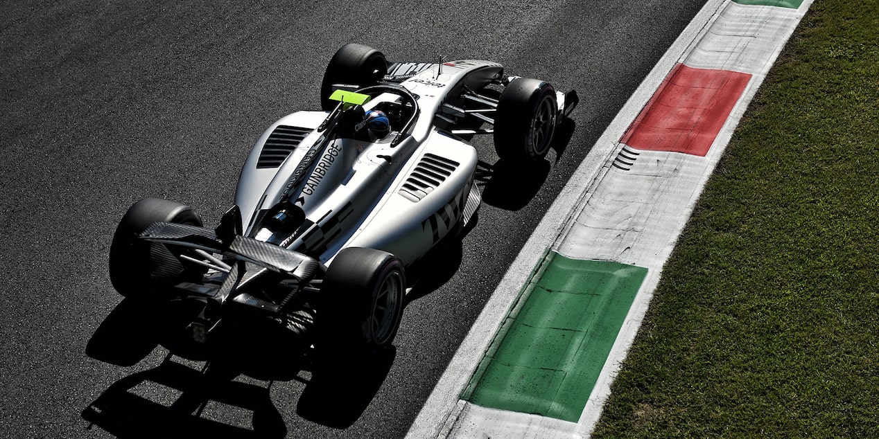 Open-Wheel F1 Cadillac Race Car Speeds Through A Corner On A Racetrack During Practice Session.
