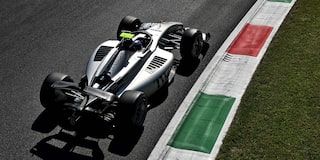 Open-Wheel F1 Cadillac Race Car Speeds Through A Corner On A Racetrack During Practice Session.