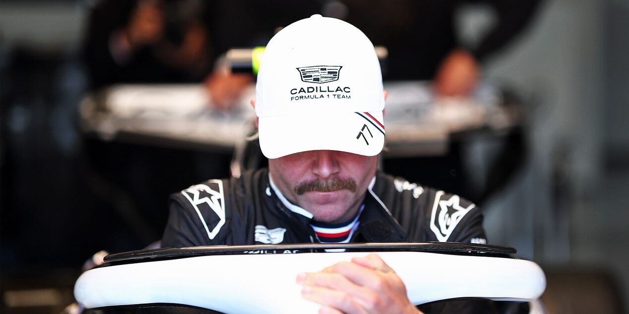 Cadillac F1 Team Driver Valtteri Bottas Sitting Inside a Race Car in a Garage