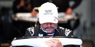 Cadillac F1 Team Driver Valtteri Bottas Sitting Inside a Race Car in a Garage