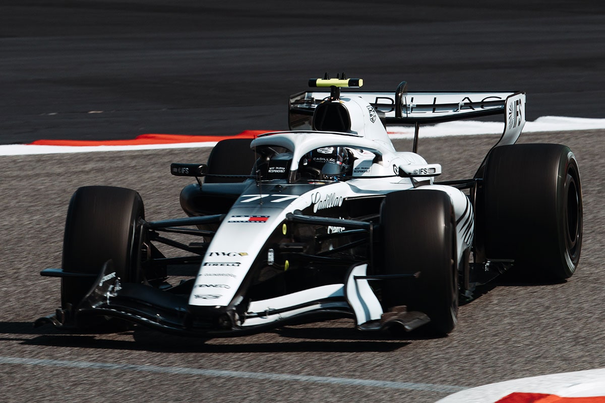 Front Three-quarters View of the White Cadillac F1 Race Car Parked on a Track
