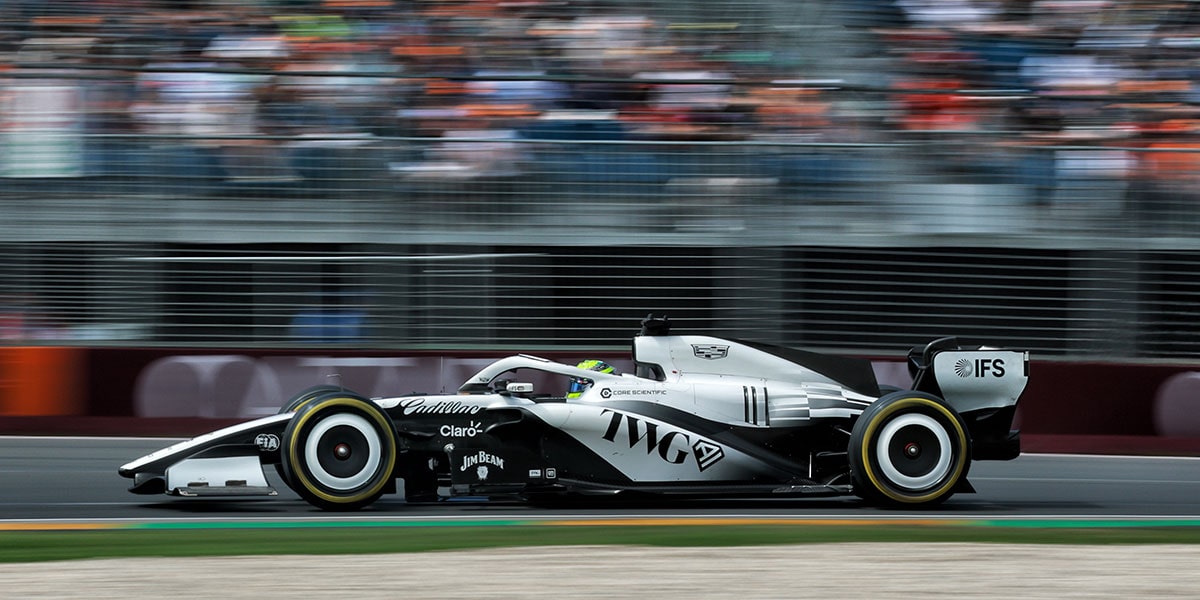 A Side View of the Cadillac F1 Racecar Speeding Down the Track