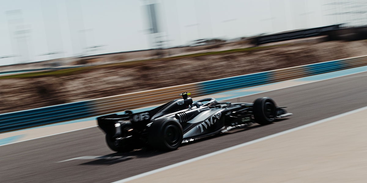 Rear Three-quarter View of a Cadillac Racecar Speeding Down a Track