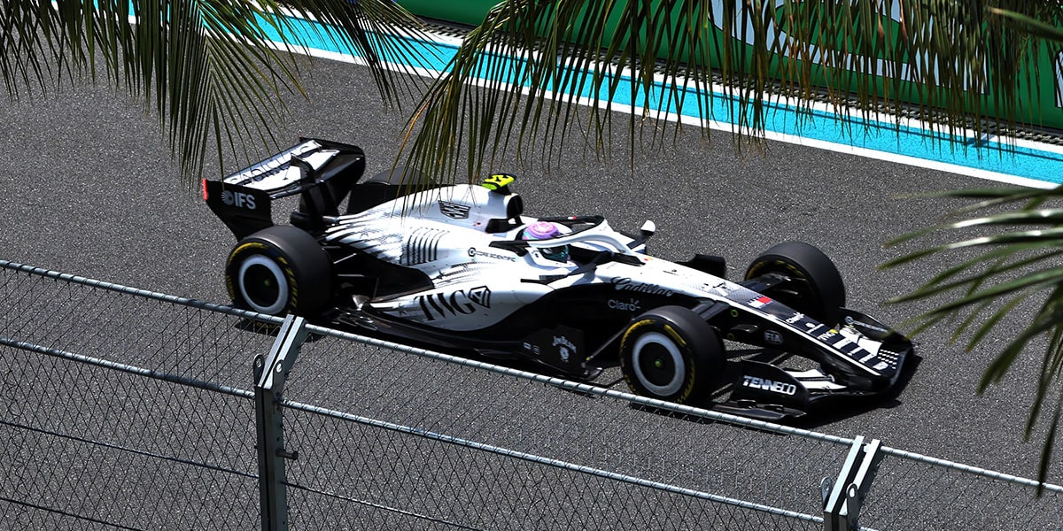 A Side View of the Cadillac F1 Racecar Speeding Down the Track