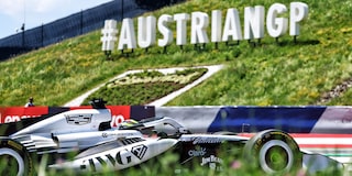 A Cadillac F1 Race Car Speeding Around a Racetrack