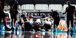 A Cadillac F1 Race Car Speeding Around a Racetrack