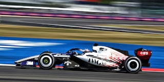 A Cadillac F1 Race Car Speeding Around a Racetrack