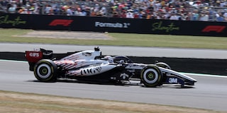A Cadillac F1 Race Car Speeding Around a Racetrack