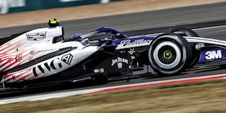 A Cadillac F1 Race Car Speeding Around a Racetrack