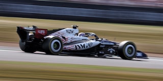 A Cadillac F1 Race Car Speeding Around a Racetrack