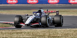 A Cadillac F1 Race Car Speeding Around a Racetrack
