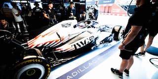 A Cadillac F1 Race Car Speeding Around a Racetrack