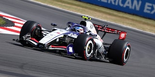 A Cadillac F1 Race Car Speeding Around a Racetrack