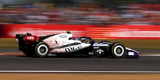 A Cadillac F1 Race Car Speeding Around a Racetrack