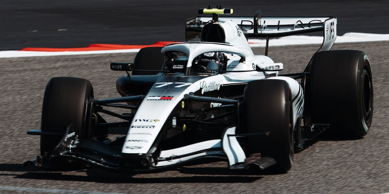 Front Three-quarters View of the White Cadillac F1 Race Car Parked on a Track