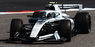 Front Three-quarters View of the White Cadillac F1 Race Car Parked on a Track