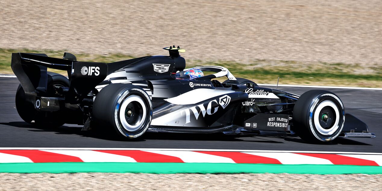 Rear Three-quarter View of a Cadillac Racecar Speeding Down a Track