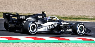 Rear Three-quarter View of a Cadillac Racecar Speeding Down a Track