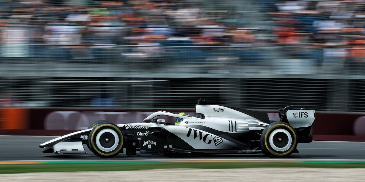 A Side View of the Cadillac F1 Racecar Speeding Down the Track