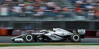 A Side View of the Cadillac F1 Racecar Speeding Down the Track