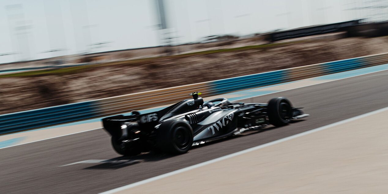 Rear Three-quarter View of a Cadillac Racecar Speeding Down a Track