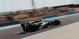 Rear Three-quarter View of a Cadillac Racecar Speeding Down a Track
