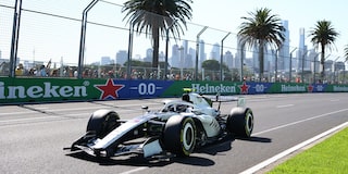 Three-quarter View of the Cadillac F1 Racecar Parked on the Track with a Cheering Audience in the Background