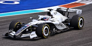 Front Three-quarters View of the White Cadillac F1 Race Car Parked on a Track
