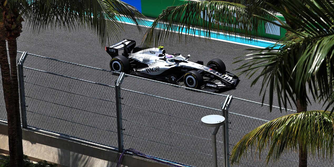 Front Three-quarters View of the White Cadillac F1 Race Car Parked on a Track
