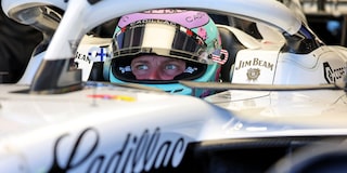 Front Three-quarters View of the White Cadillac F1 Race Car Parked on a Track