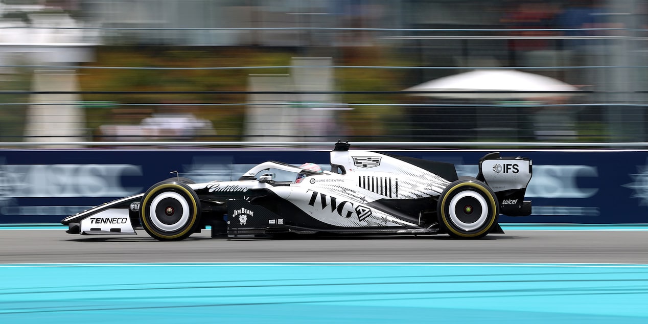 Front Three-quarters View of the White Cadillac F1 Race Car Parked on a Track