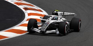 Front Three-quarters View of the White Cadillac F1 Race Car Parked on a Track