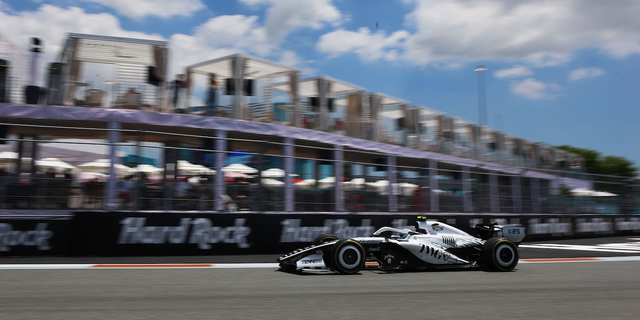 Front Three-quarters View of the White Cadillac F1 Race Car Parked on a Track