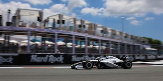 Front Three-quarters View of the White Cadillac F1 Race Car Parked on a Track