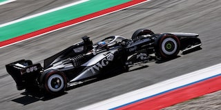 A Cadillac F1 Race Car Speeding Around a Racetrack