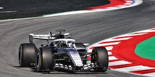A Cadillac F1 Race Car Speeding Around a Racetrack