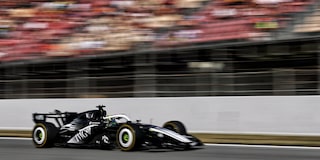 A Cadillac F1 Race Car Speeding Around a Racetrack