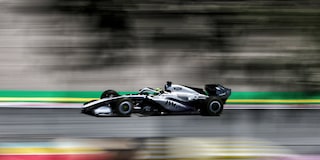 A Cadillac F1 Race Car Speeding Around a Racetrack