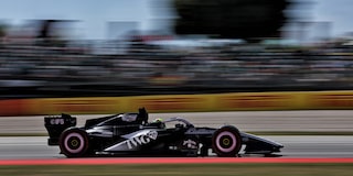 A Cadillac F1 Race Car Speeding Around a Racetrack