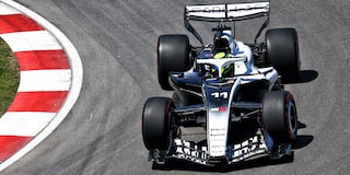 Overhead View of a Cadillac F1 Race Car Rounding a Track Corner