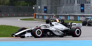 A Cadillac F1 Race Car Speeding Around a Racetrack Corner
