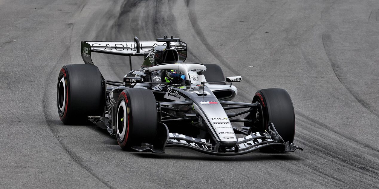 A Cadillac F1 Race Car Speeding Around a Racetrack