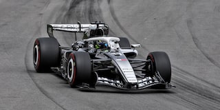A Cadillac F1 Race Car Speeding Around a Racetrack