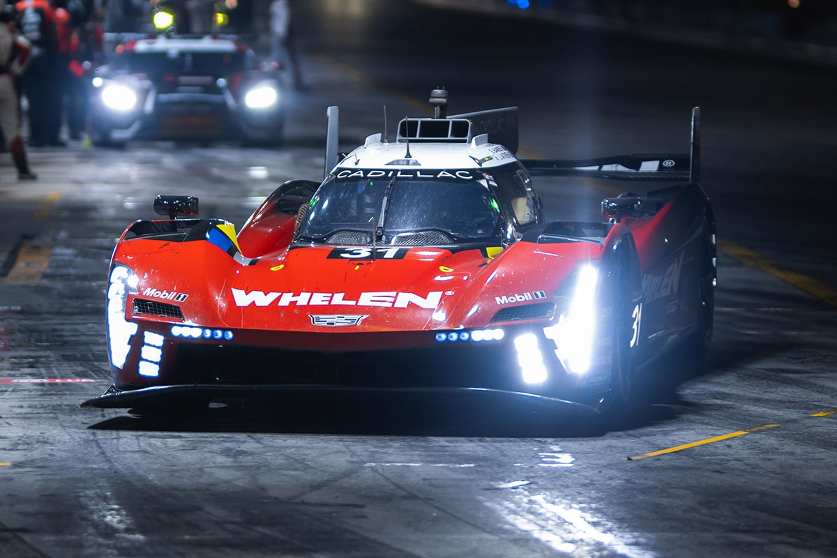 Side Profile View of the No.40 Cadillac V-Series.R Race Car Parked at a Pit Stop with Crew Members