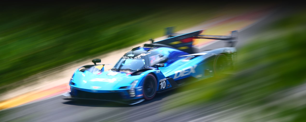 Bird-eye View of the Blue Cadillac V-Series.R Race Car Speeding Down a Track