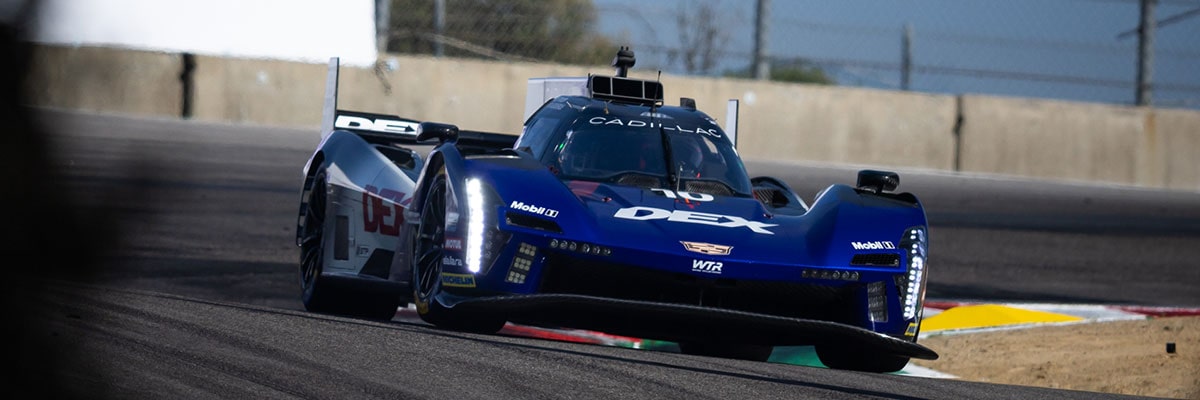 Side View of the Red No. 31 Whelen Engineering Cadillac V-Series.R Racecar Speeding on a Track