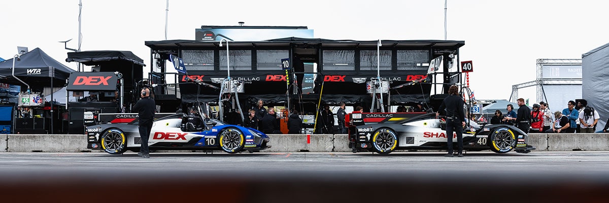 Side View of the No.10 and No.40 Cadillac V-Series.R Racecars Parked at a Pit Stop on a Race Track