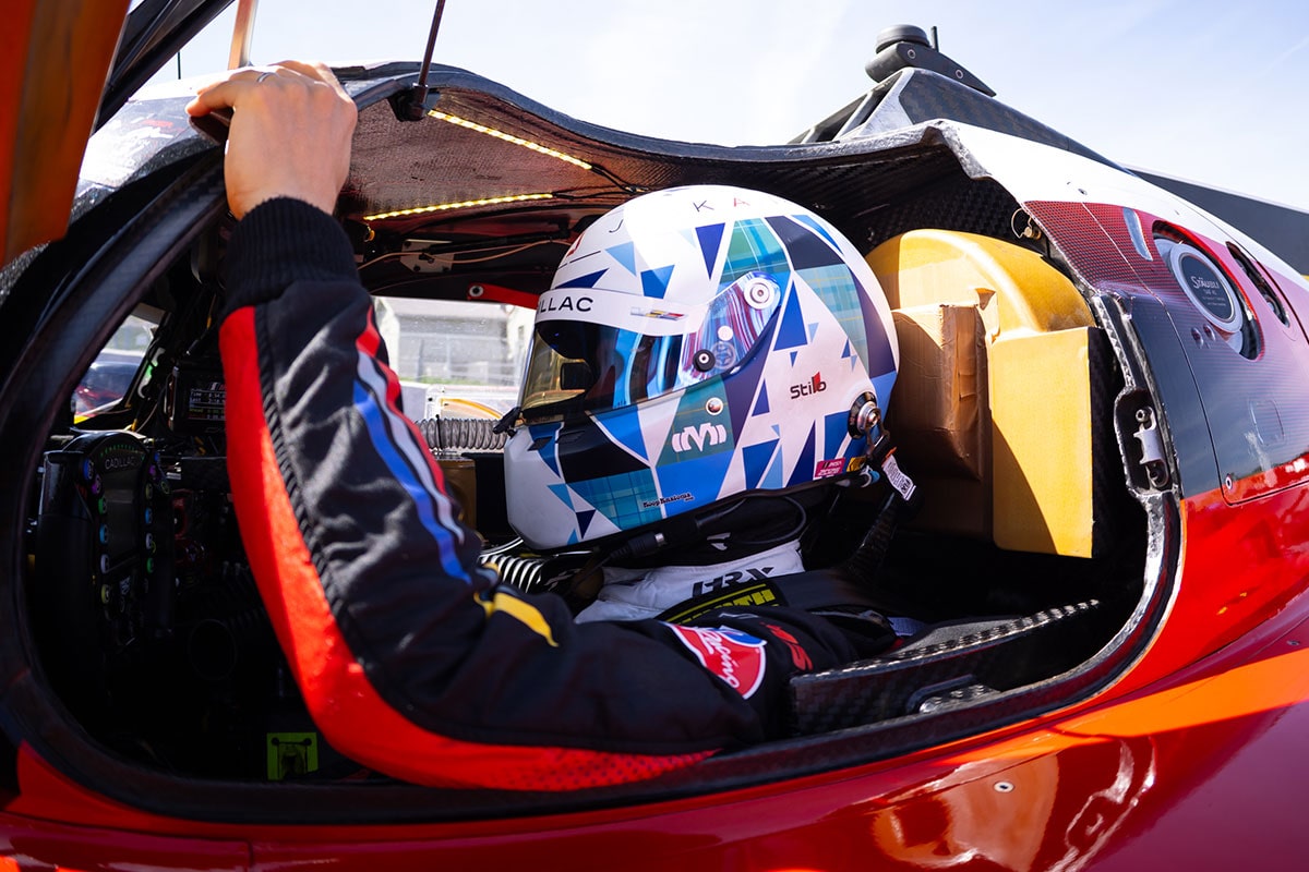 Close-up of a Cadillac Driver Wearing a Helmet Inside the Racecar with the Butterfly Door Open
