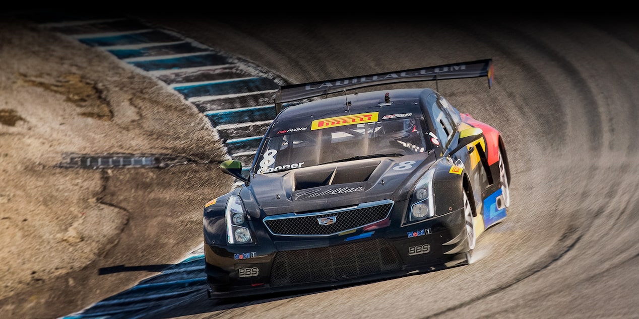 The Cadillac Racing ATS-V.R Heritage Race Car Fiercely Driving on the Curve of a  Track